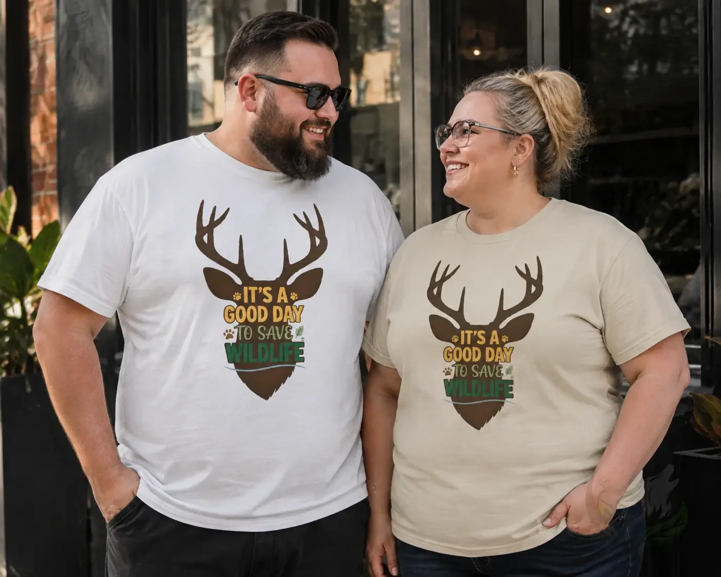 Plus-size couple wearing White and Natural Raw shirts with cartoon deer wildlife designs.