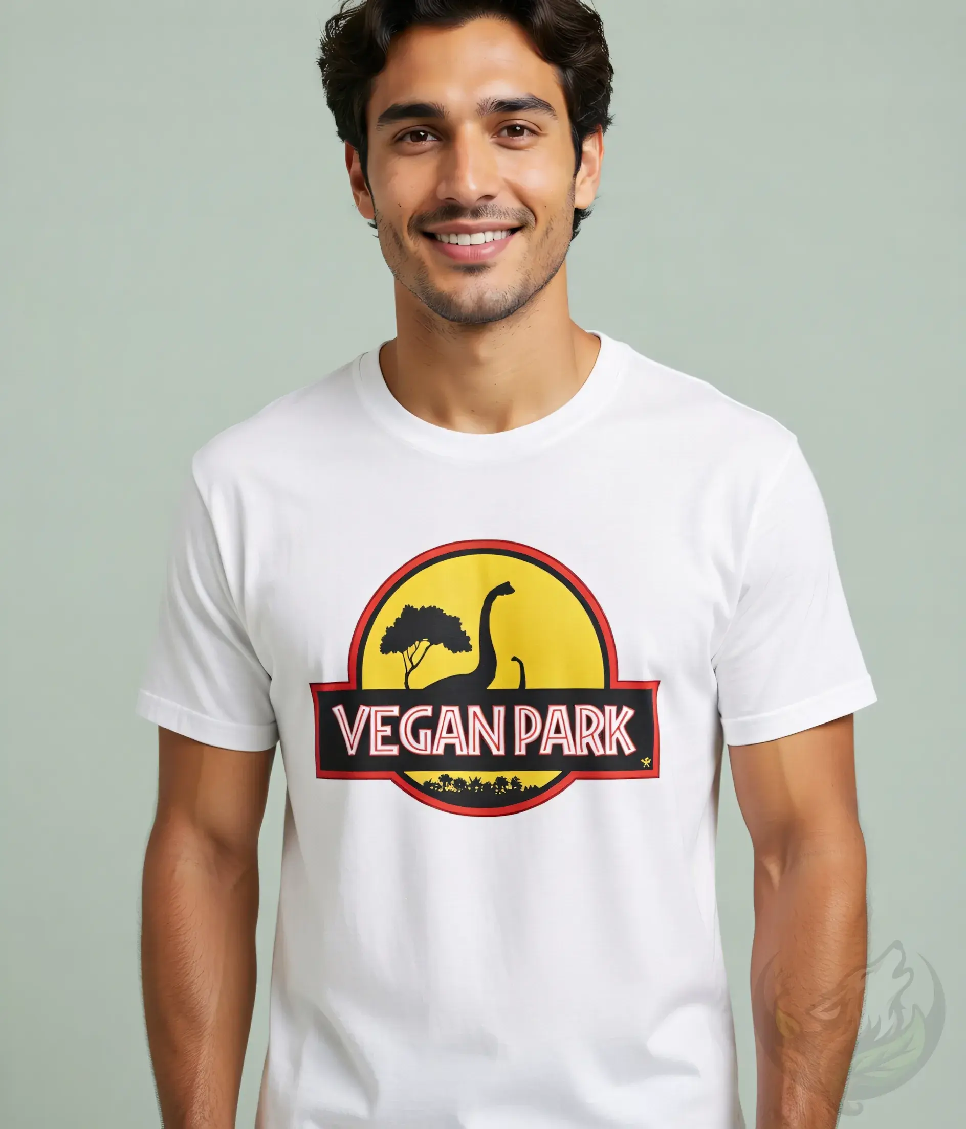 White unisex t-shirt close-up on man with dark hair, "VEGAN PARK" dino graphic.