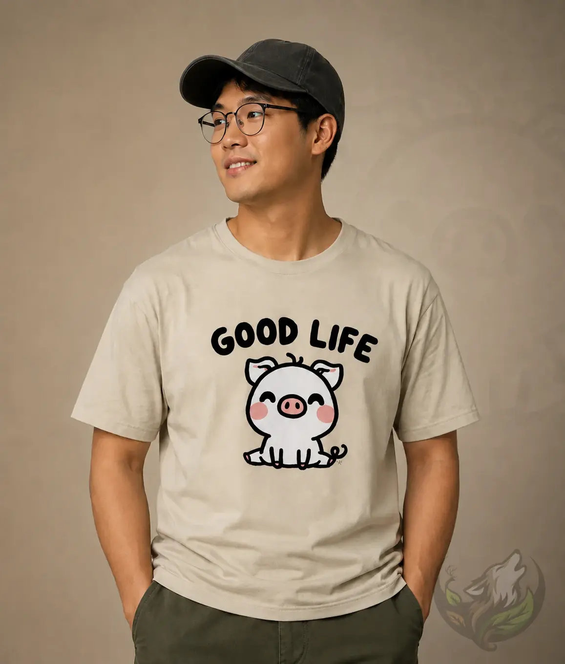 Natural unisex shirt with cute Good Life pig cartoon design worn by man in warm neutral studio scene