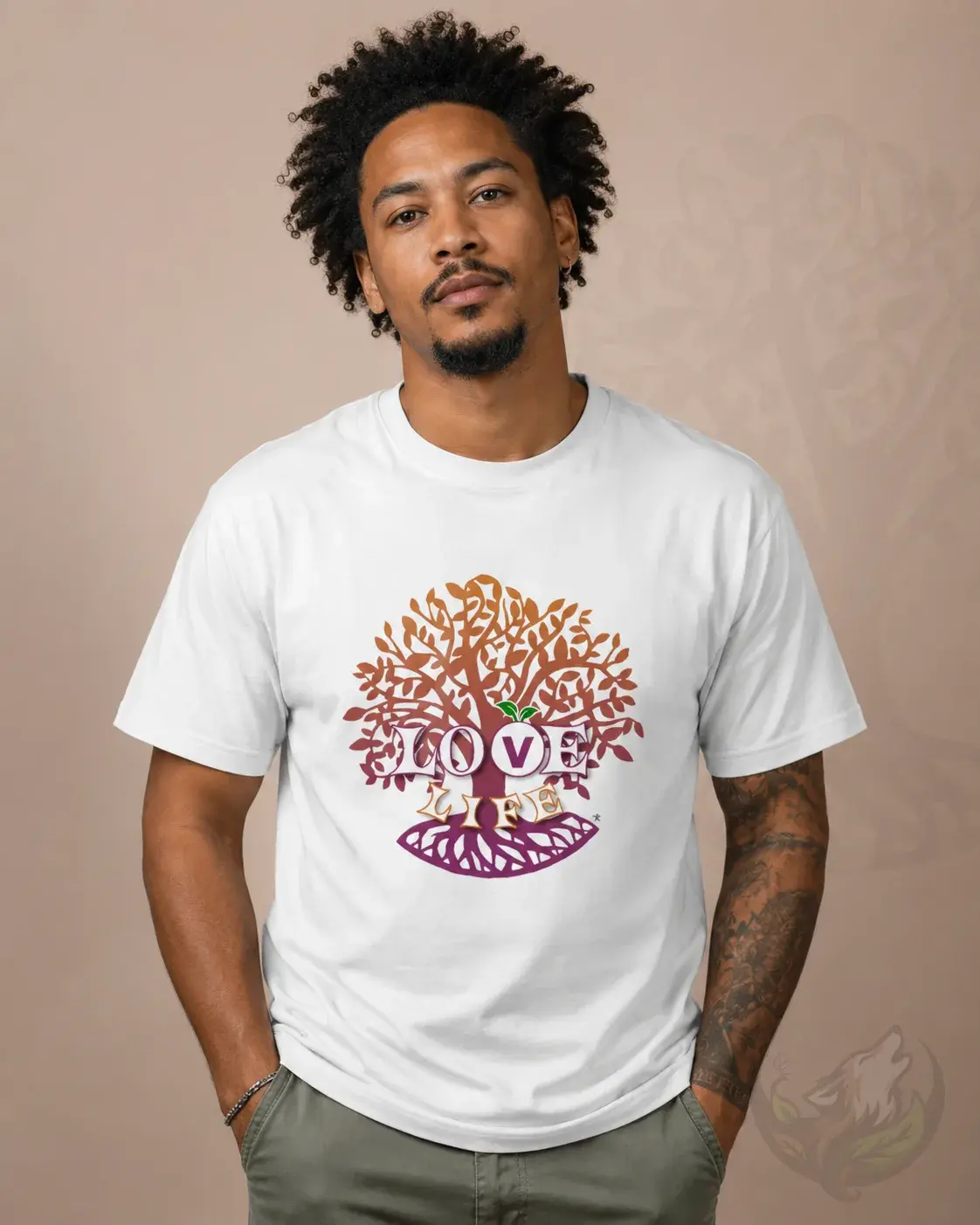 White unisex shirt with colorful Love Life tree artwork worn by tattooed man in clean studio portrait