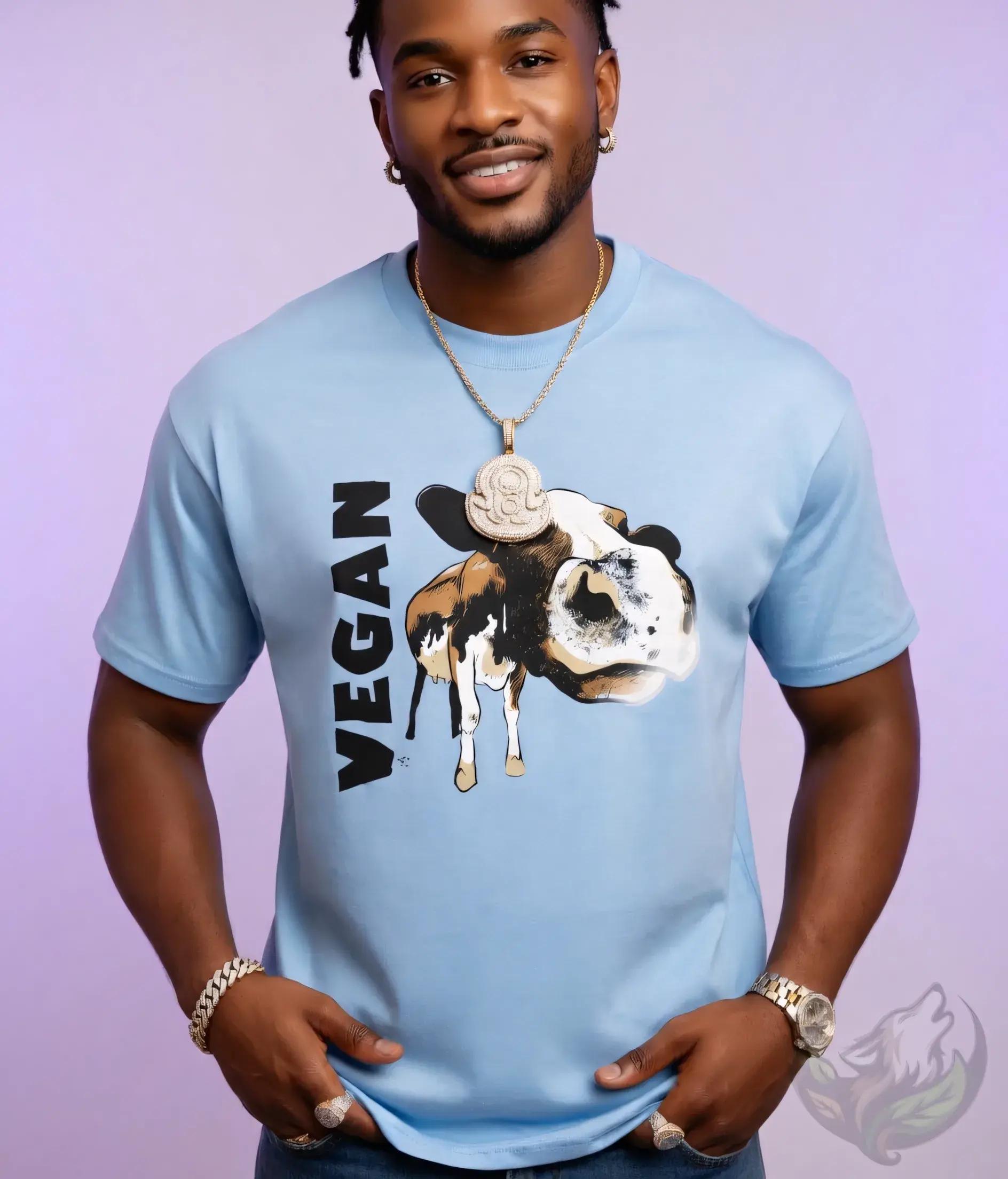 Light blue unisex t-shirt on man with dreads and gold chain, "VEGAN" cow graphic.