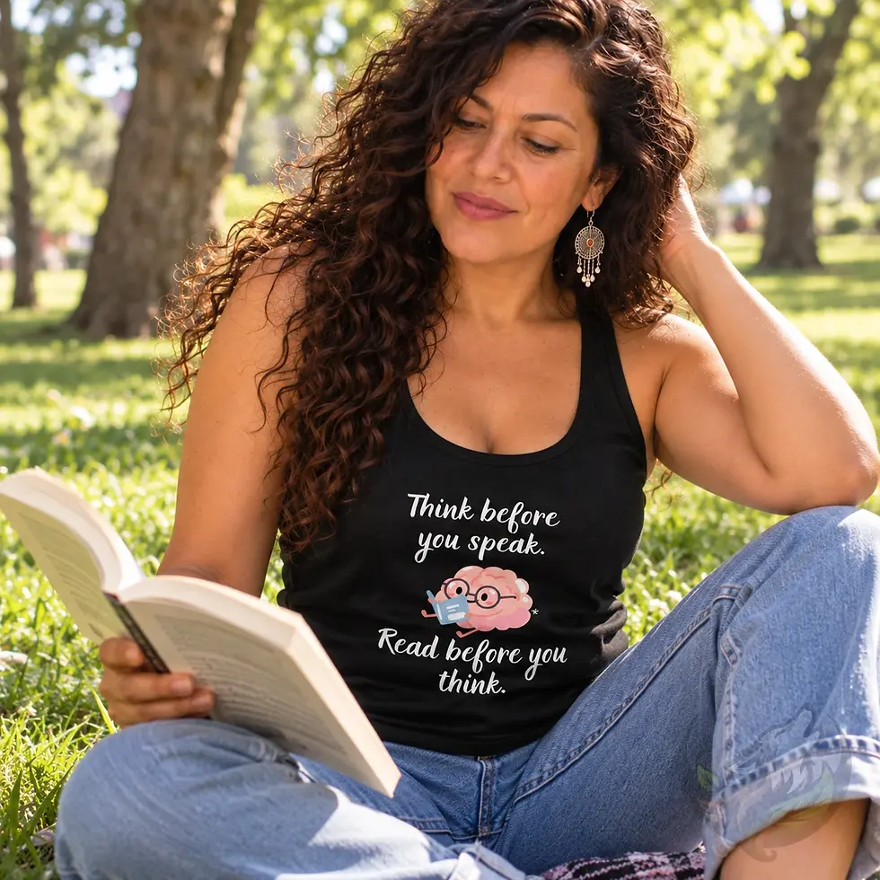 Woman reading a book in a park while wearing a black tank top with a cartoon brain and reading quote