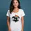 Thumbnail: Woman in a white scoop neck tee showcasing the colorful elephant design in a well-lit studio setup.