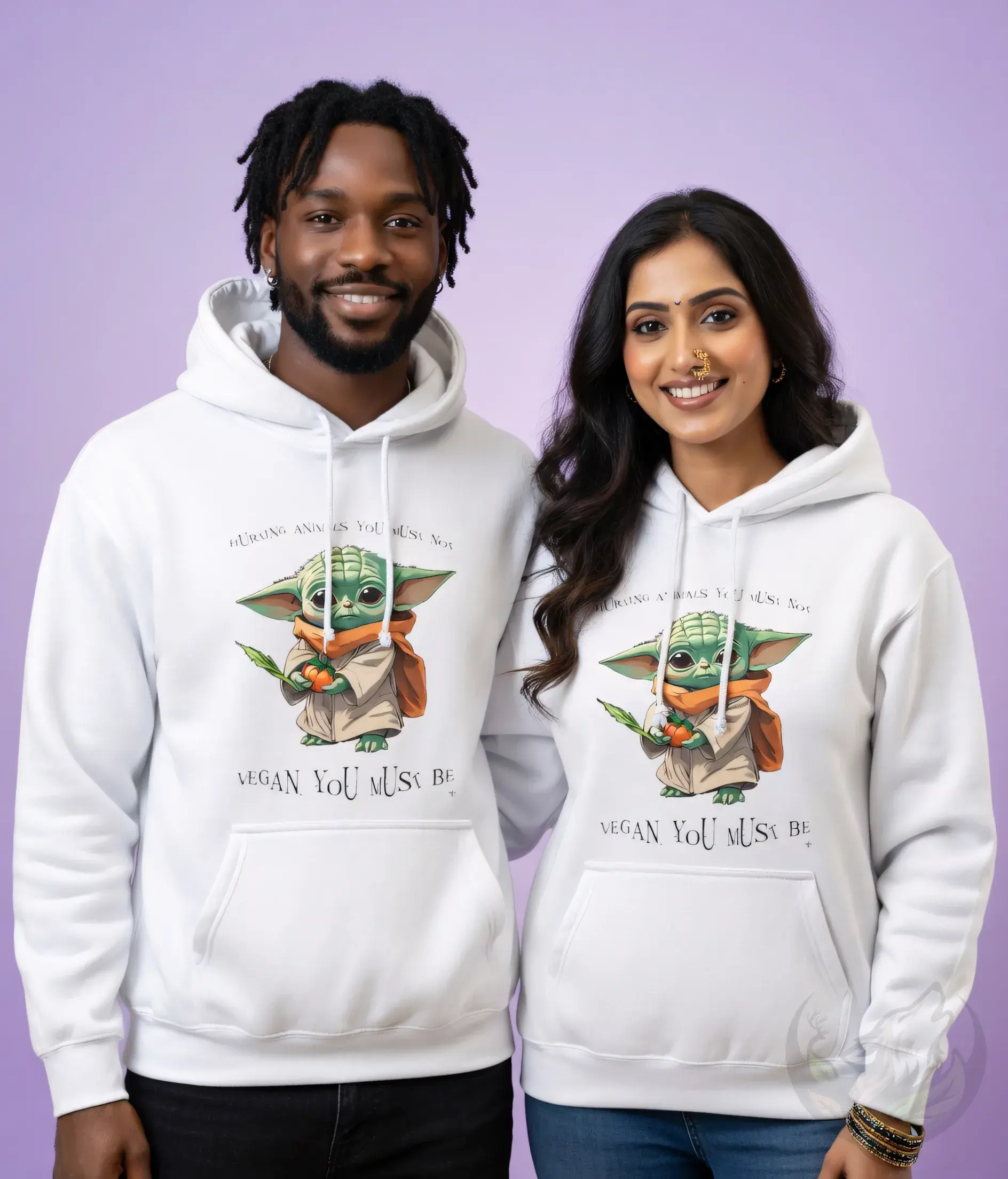Couple wearing matching white unisex hoodies with cute cartoon Grogu holding a sprout and VEGAN YOU MUST BE text
