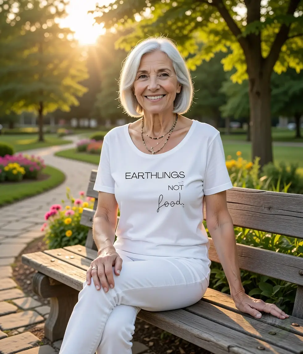 Thumbnail: White scoop‑neck tee with the Vegan Quotes “Earthlings Not Food” design worn on a park bench at sunset.