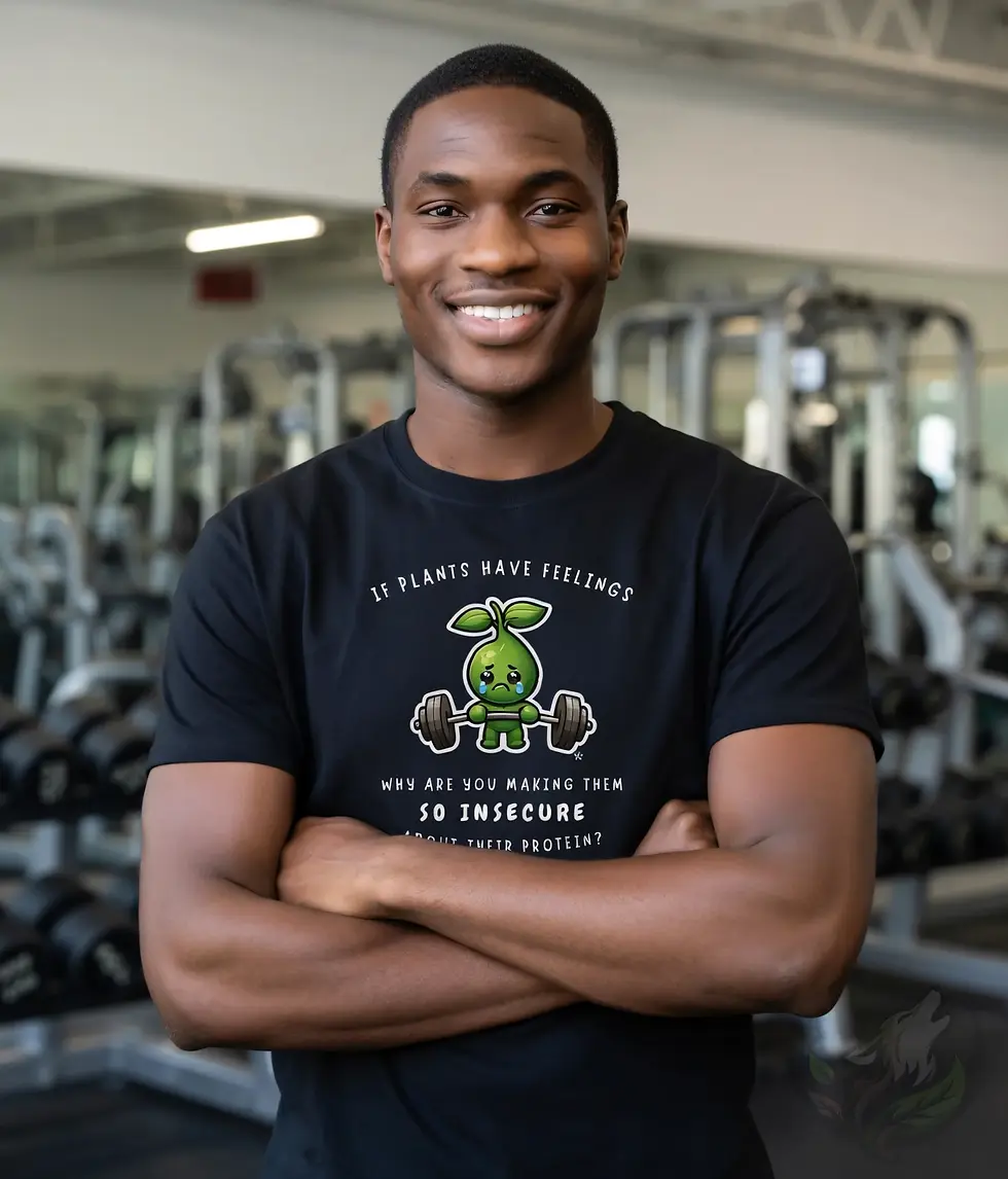 Black unisex t-shirt on smiling man in gym, "If Plants Have Feelings Why Are You Making Them So Insecure About Their Protein?