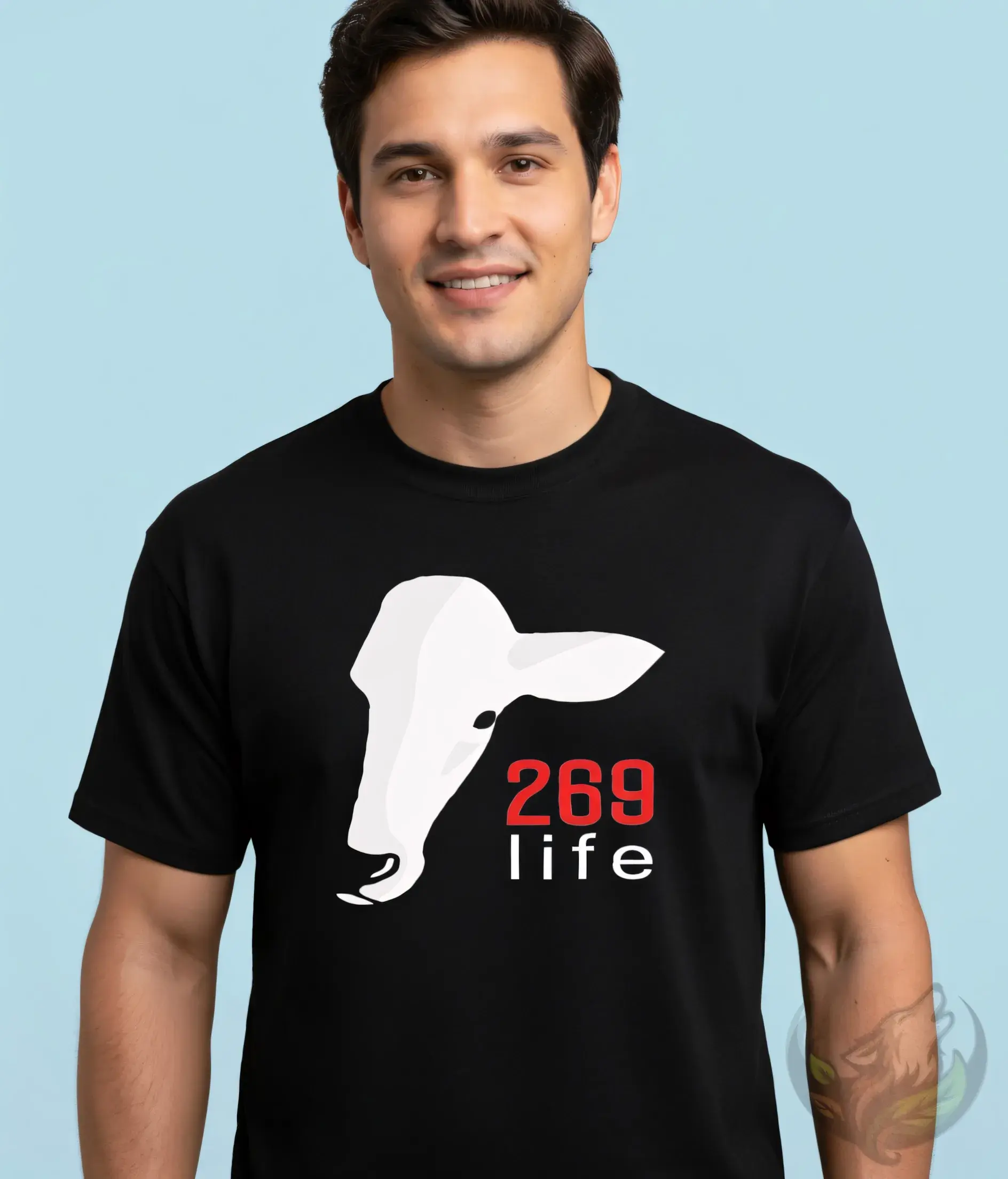 Black unisex t-shirt close-up on smiling man, white cow head graphic with "269 life" text.