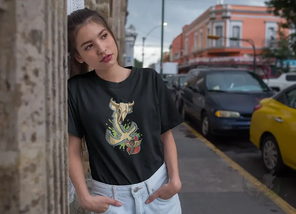 Woman leaning against a stone wall wearing a black fitted tee featuring Def P’s Twisted Cross skull and abstract artwork