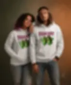 Couple wearing white unisex Peas Out hoodies with funny pea graphic in studio.