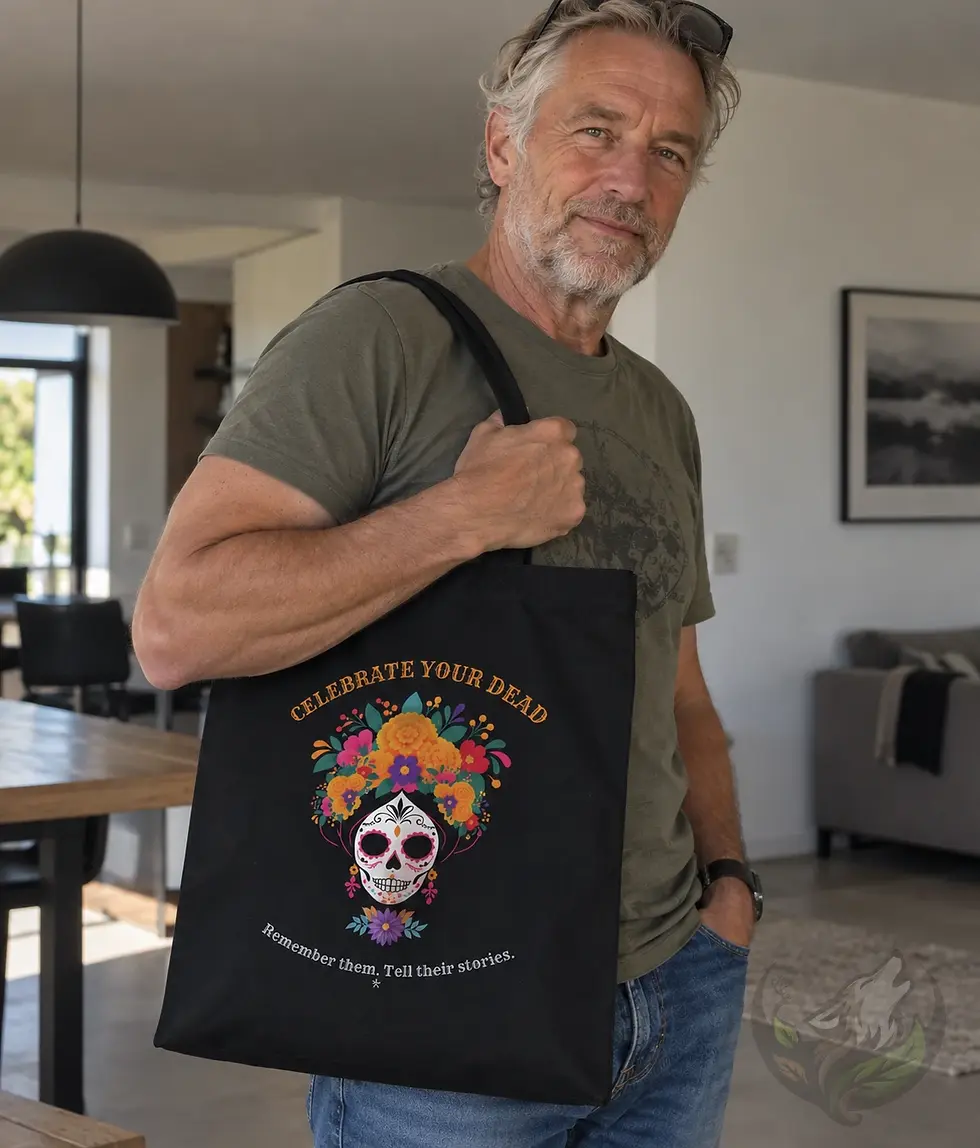 Older man holding a black Tell Their Stories tote bag with colourful Day of the Dead floral sugar skull artwork