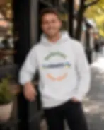 Thumbnail: Man wearing light grey unisex hoodie with One Big Heart Humanity Many Colours design outdoors