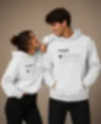 Couple wearing matching white unisex People Ratings hoodies in a clean studio portrait with the humorous one star review desi