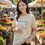 Thumbnail: Beige fitted tee with the Vegan Quotes “Earthlings Not Food” design worn while shopping at an outdoor market.