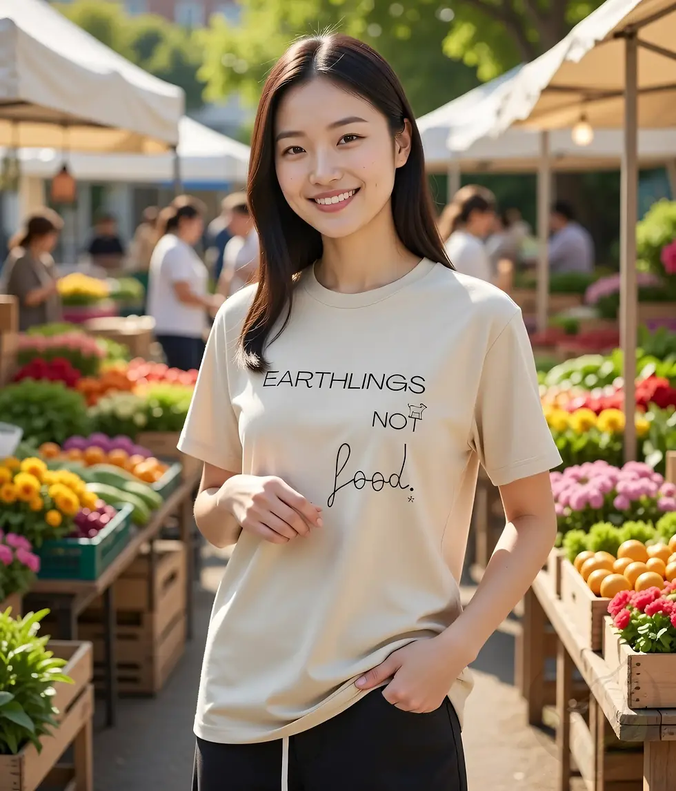 Thumbnail: Beige fitted tee with the Vegan Quotes “Earthlings Not Food” design worn while shopping at an outdoor market.
