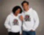 Couple wearing white unisex hoodies with matching angry graffiti strawberry designs.