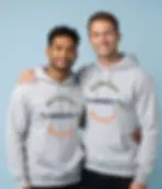 Two men wearing light grey unisex hoodies with One Big Heart Humanity Many Colours design