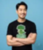 Black unisex t-shirt worn by smiling man, "Kale Yeah, I'm Vegan!" muscular kale superhero cartoon.