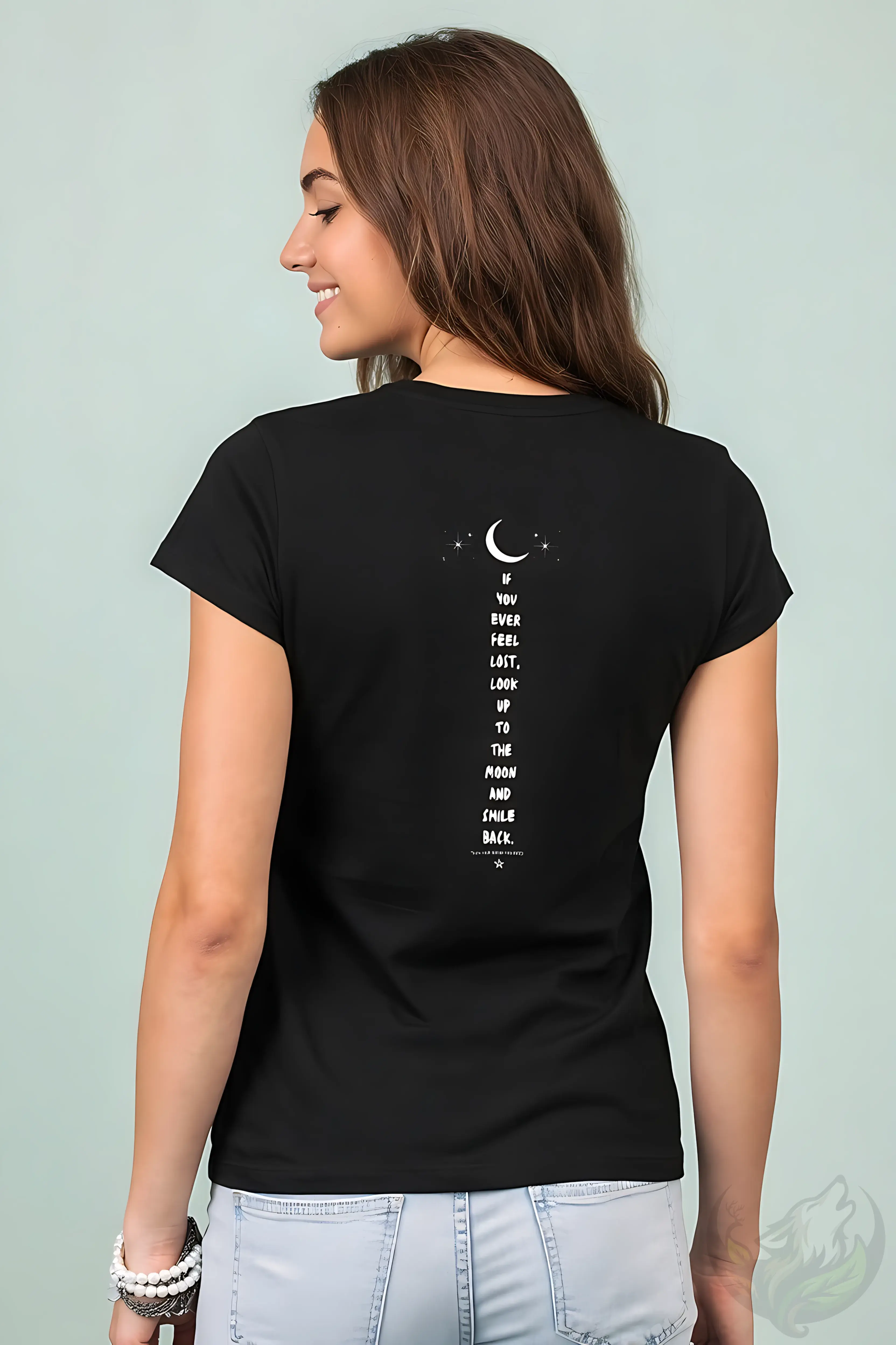 Woman in black fitted t-shirt with moon and stars on back and motivational quote about feeling lost.