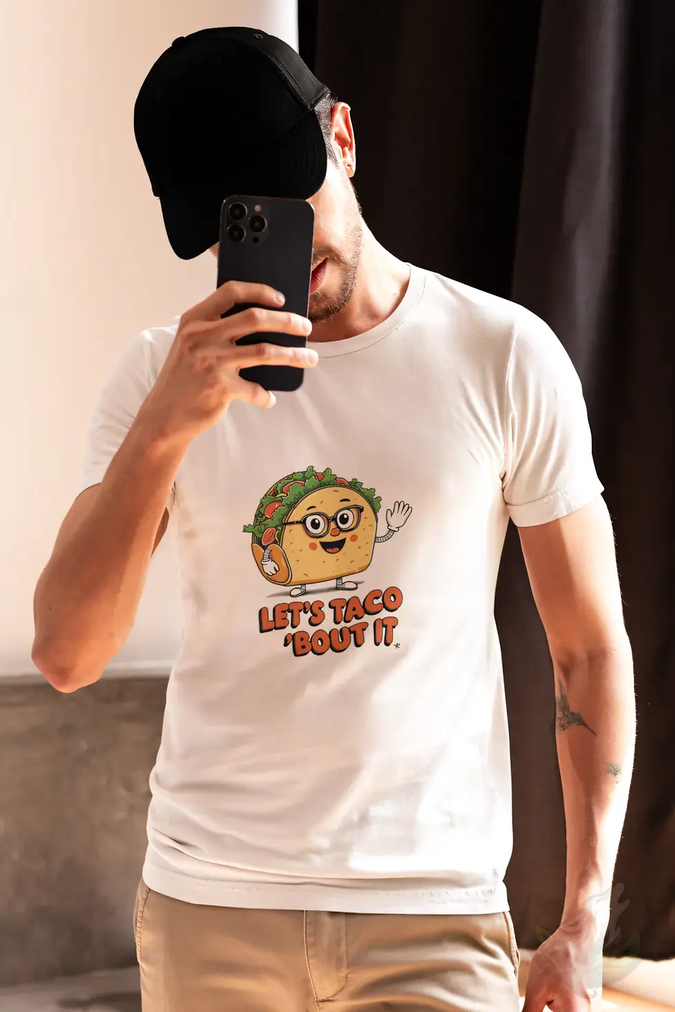 Thumbnail: Smiling man wearing white Let's Taco 'Bout It taco food pun shirt holding a fresh taco