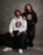 Couple wearing white and black Official DefP Griffin Unisex Hoodies featuring the Griffin design.