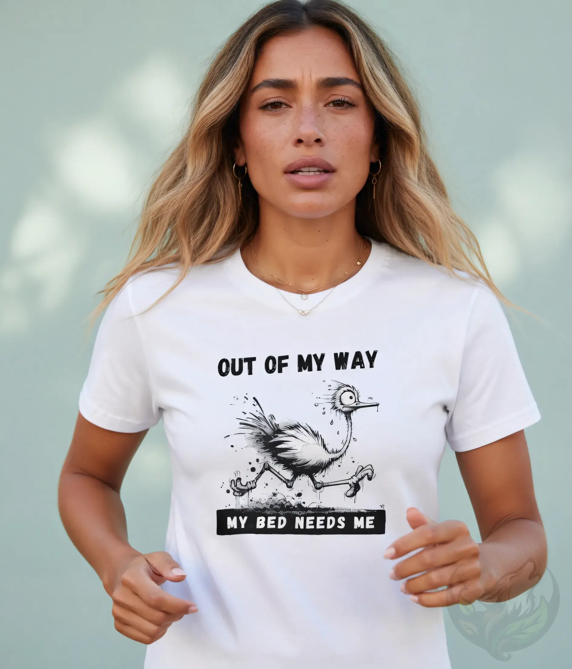Woman with long blonde-highlighted hair wearing a white fitted t-shirt with "Out of My Way - My Bed Needs Me" funny ostrich g
