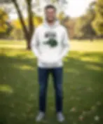 Man wearing white 'I'm Kind Of A Big Dill' funny food pun hoodie standing in a green park outdoors.