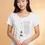 Thumbnail: White wide‑neck shirt worn by a woman with a vertical illustration and the Rational Beings quote on the front.