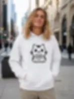Man wearing a white Good Life Cat hoodie featuring a cute kitten holding a heart in an urban street setting