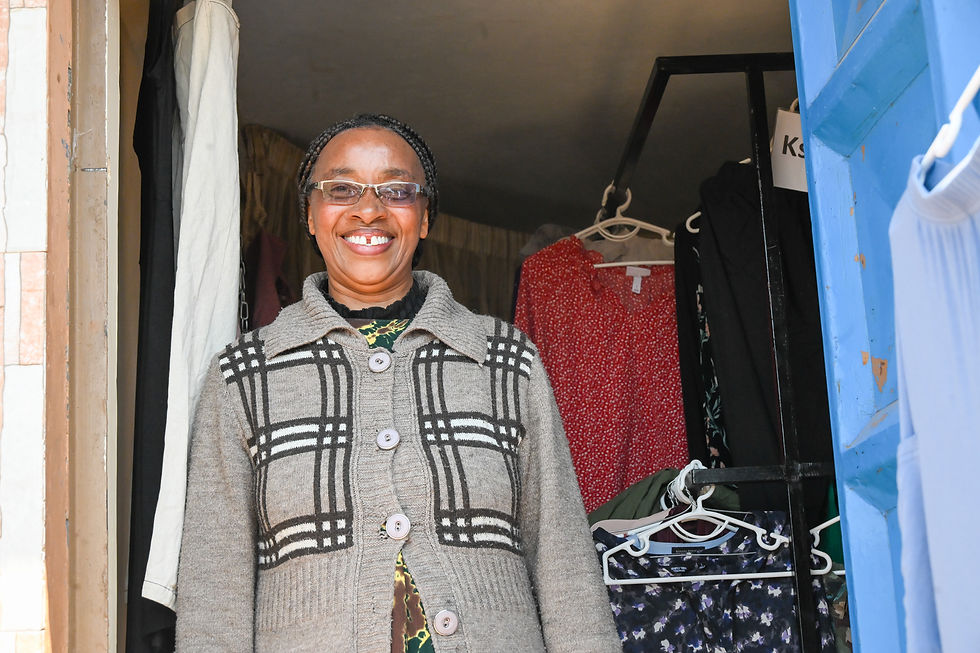 Teresia in front of her business