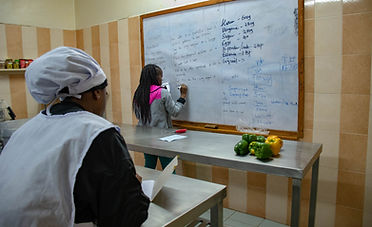 a hospitality student taking notes in class