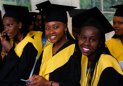 hospitality female students smiling and wearing graduation gowns