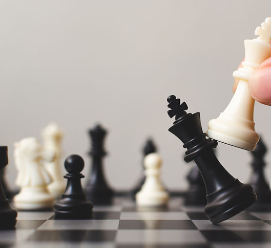 chess piece toppling over on a chess board