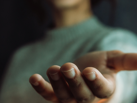 A hand reaching out to support