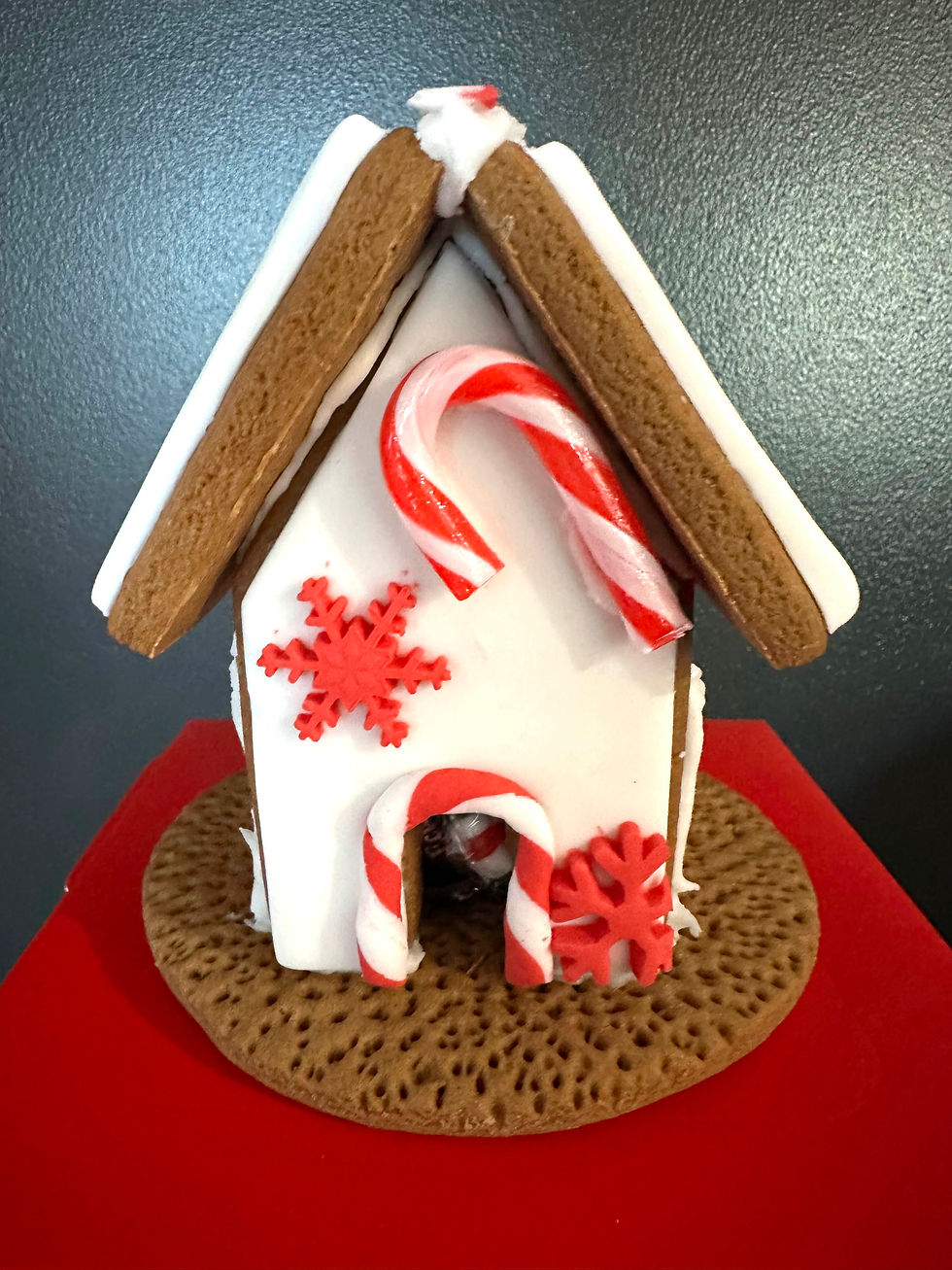 Gingerbread house decorated with candy canes and snowflakes