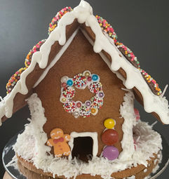 gingerbread house with shredded coconut snow base