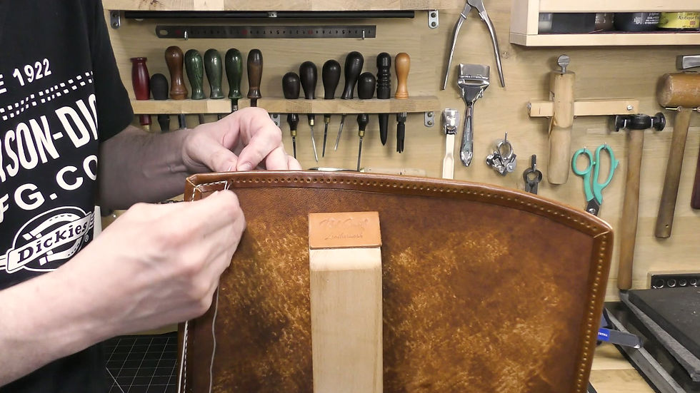 Saddle stitching the body of a handmade leather satchel by hand with two needles