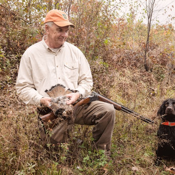 Jack and Boykin Spaniel with a Grouse
