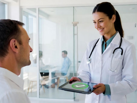 Doctor showing a patient a tablet with a green checkmark, representing medical records and physician letters for apostille
