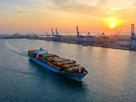 Container ship leaving a port at sunset representing certificates of origin and export documents