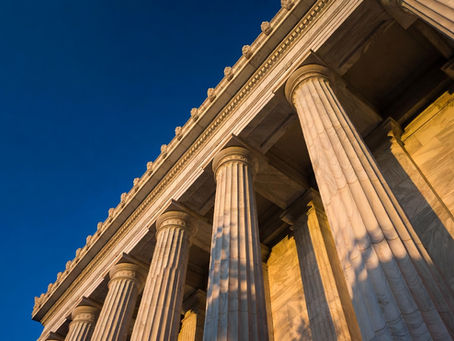 Marble courthouse columns representing county clerk certification before a state apostille