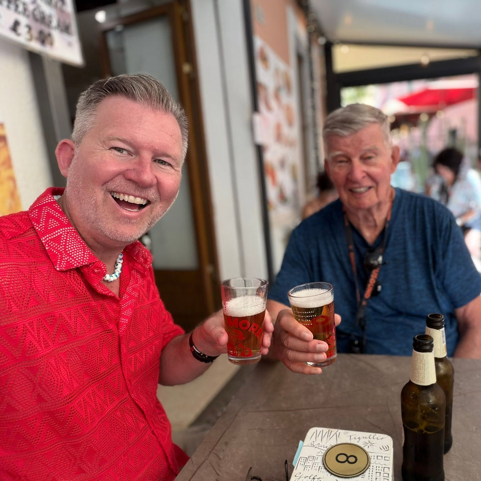 Father and son enjoying a beer together while exploring Europe cultivating Kinship