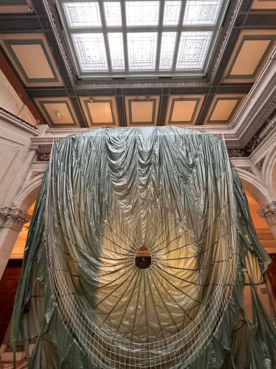 Paul Emmanuel: Untethered
2024
MFA thesis installation in the main building court of Maryland Institute College of Art, Baltimore MD, USA.
Part of Grad Show 3, Mount Royal School of Art (Multidisciplinary MFA) 2024 thesis group exhibition, curated by Professor Luca Buvoli.
Decommissioned, model T-10, US military personnel parachute with severed suspension lines, detached harness with risers, 550 para-cord. High-definition video projection, stereo soundtrack (8 min 7 sec).
Parachute diameter: 35 feet
Harness dimensions: 30 x 30 inches (excluding suspension lines).