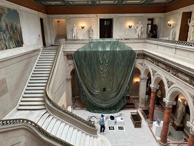 Paul Emmanuel: Untethered
2024
MFA thesis installation in the main building court of Maryland Institute College of Art, Baltimore MD, USA.
Part of Grad Show 3, Mount Royal School of Art (Multidisciplinary MFA) 2024 thesis group exhibition, curated by Professor Luca Buvoli.
Decommissioned, model T-10, US military personnel parachute with severed suspension lines, detached harness with risers, 550 para-cord. High-definition video projection, stereo soundtrack (8 min 7 sec).
Parachute diameter: 35 feet
Harness dimensions: 30 x 30 inches (excluding suspension lines).