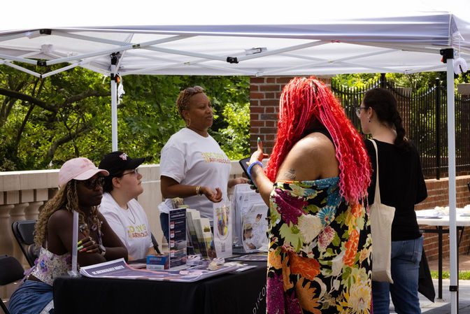 People talking at an Archaeology in the Community information table during the DC Day of Archaeology Festival.