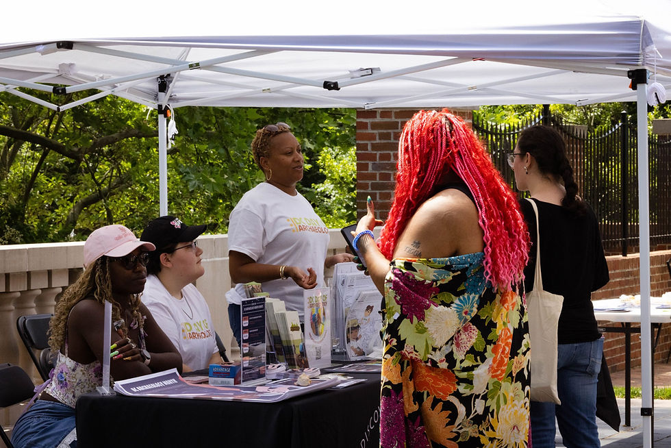 Archaeology in the Community booth with people gathered for conversation at a public outreach event.