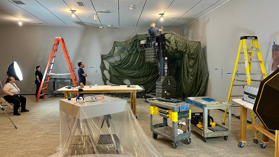 Museum installation team members using ladders and a lift to install Paul Emmanuel’s Untethered/Retethered at the Smithsonian National Museum of African Art.