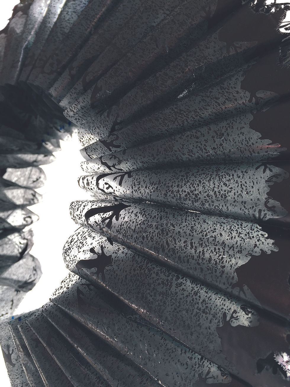Close detail of the folded carbon paper ruff structure in Paul Emmanuel’s Rough Collar.