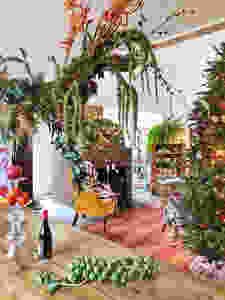 Interior Christmas jungle with weeping above head centerpiece.