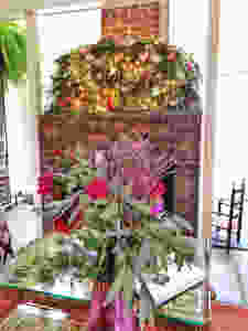 fireplace mantle with thick garland and floral arrangement