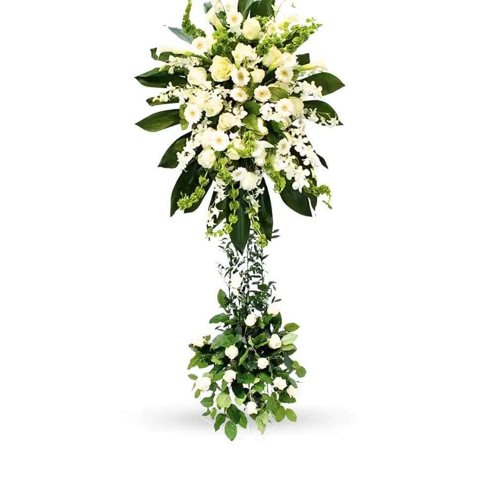 Elegant all-white floral tribute with tropical leaves – Flowers by Mike NY serving East Rockaway & Oceanside